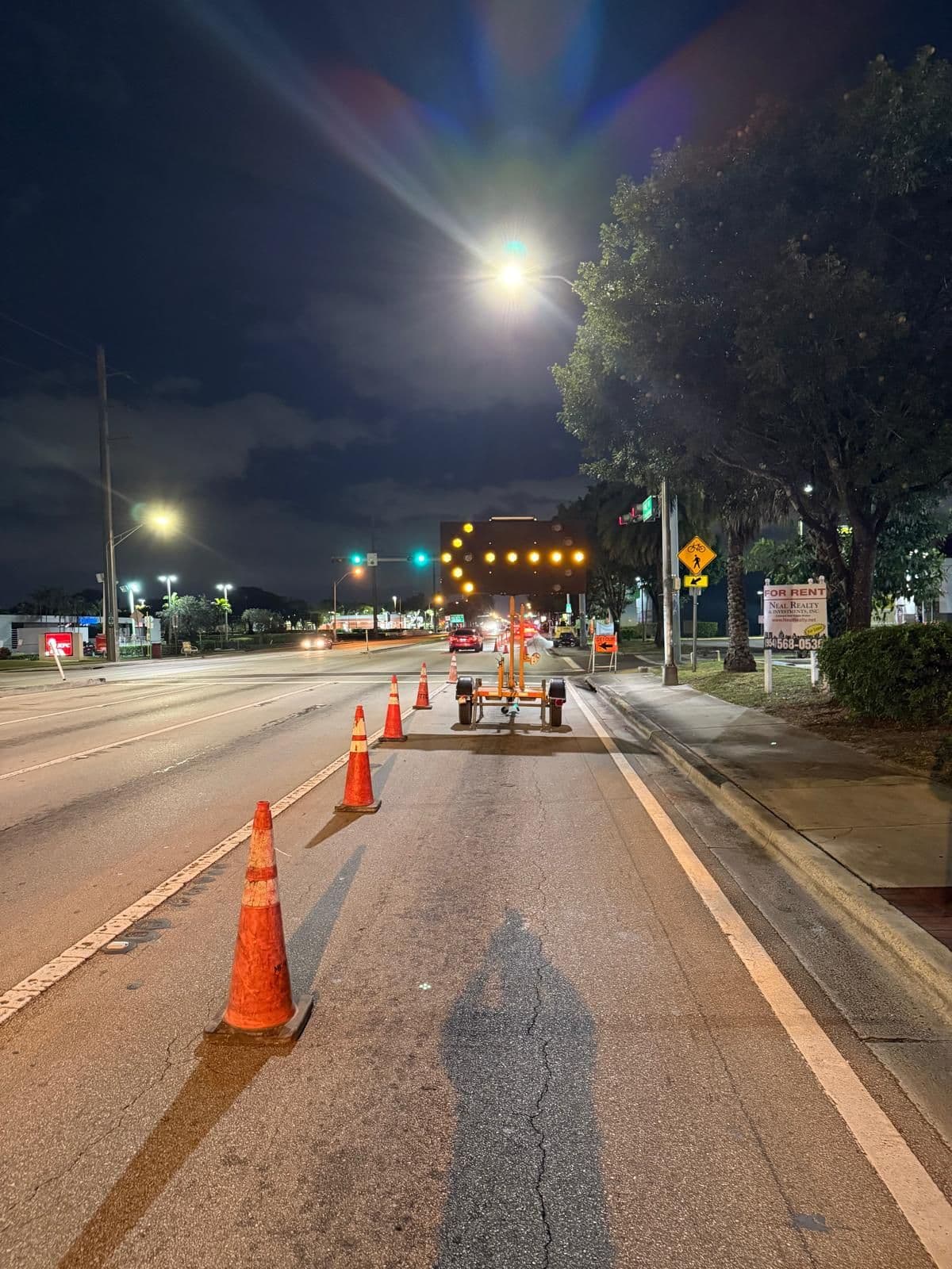 Bore Tech controlled roadway work zone with cones and traffic safety equipment at night.