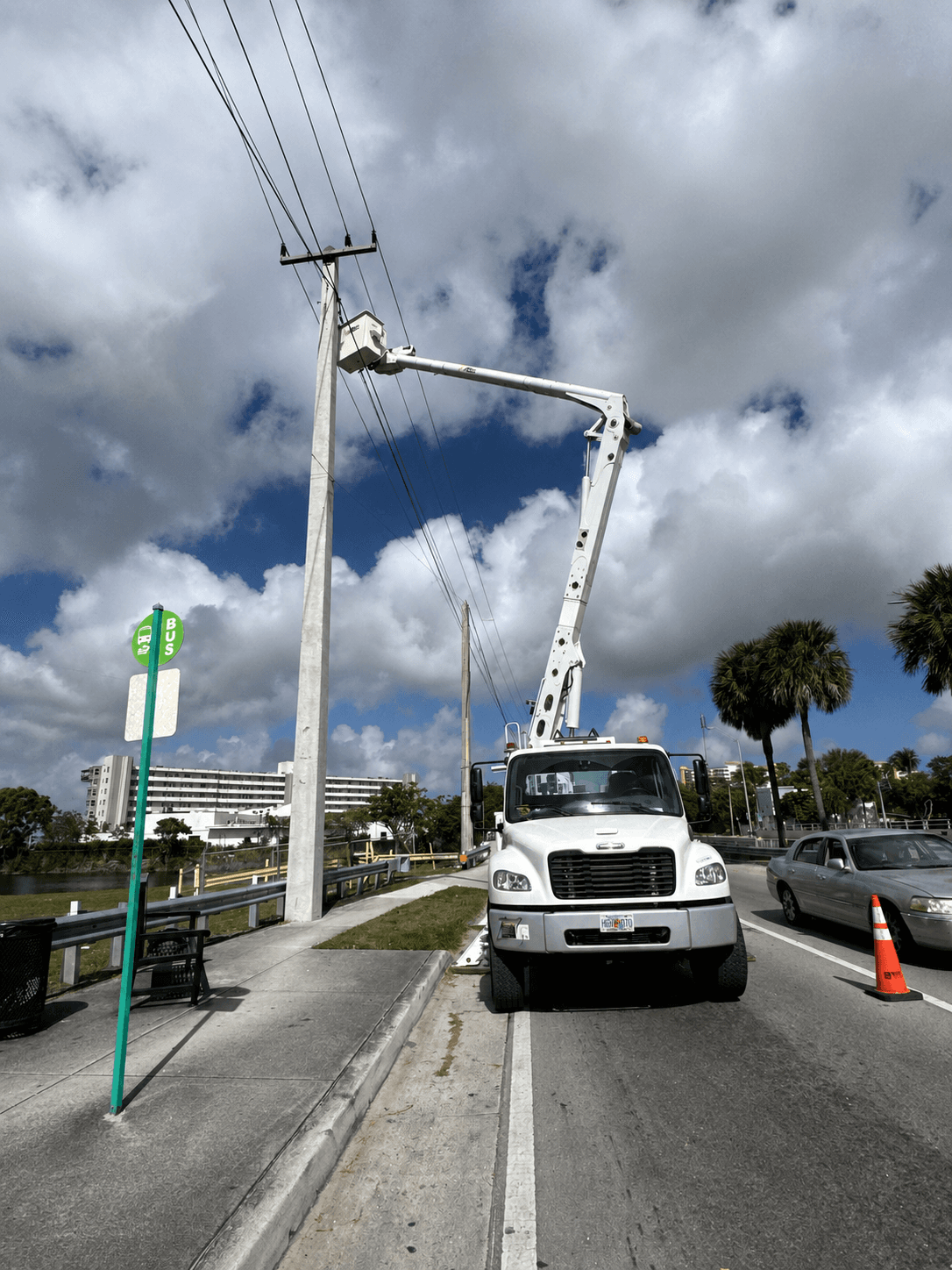 Power Division crew performing overhead utility line work with a bucket truck.